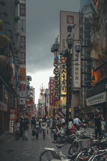 Busy city street with people walking, talking, and going about their day. The image represents the intuitive personality types, including ENFP, INFP, ENTP, INTP, ENFJ, INFJ, ENTJ, and INTJ, who are characterized by their use of intuition (Ne and Ni) in systems such as MBTI, Physiotype, Socionics, and OPS.