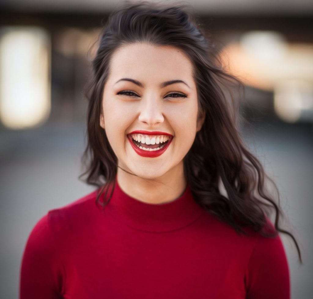 Happy smiling girl showing satisfaction with her Physiotype test results, a visual typing personality test similar to MBTI, Socionics, and Objective Personality System.