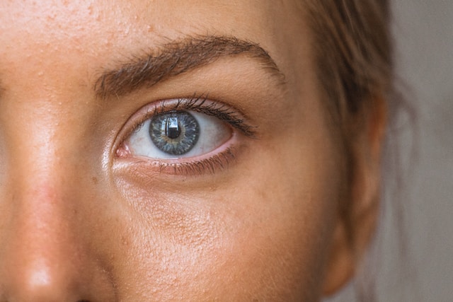 Close-up image of an eye with distinct facial features, suggesting the potential for facial analysis to predict personality traits, as indicated by a research paper.